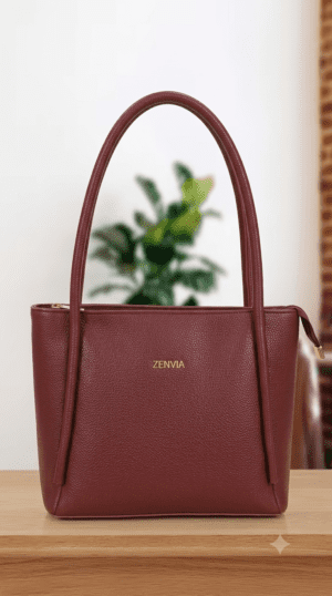 Front view of Zenvia premium maroon tote bag with gold branding logo.